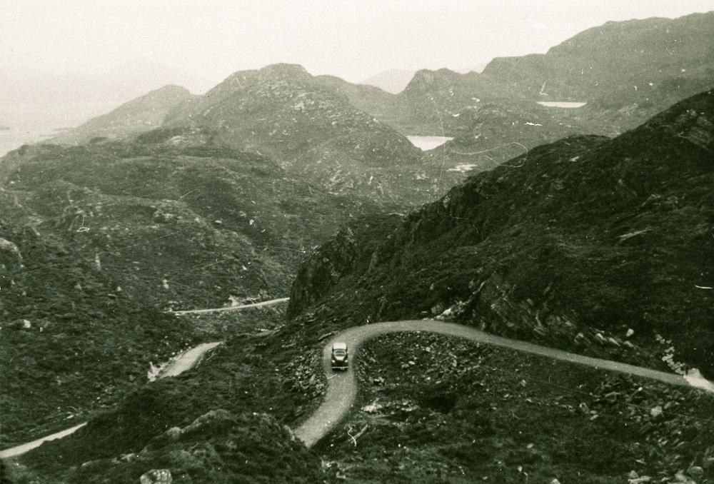 Eldre bilete av veg på fjell, svingar, bil. 